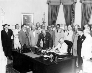 President Truman signs the National Security Act Amendment of 1949 in the Oval Office