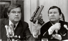 HSCA chairman Frank Church and holds a CIA developed poison dart gun to causes cancer and induce a heart attack.